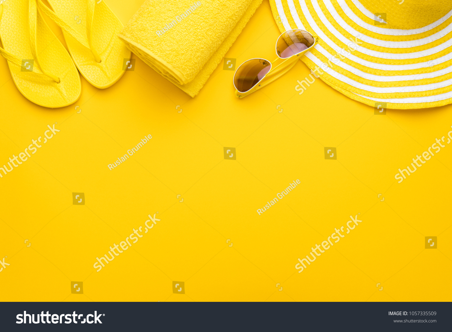 beach accessories on the yellow background - sunglasses  towel. flip-flops and striped hat. summer is coming concept