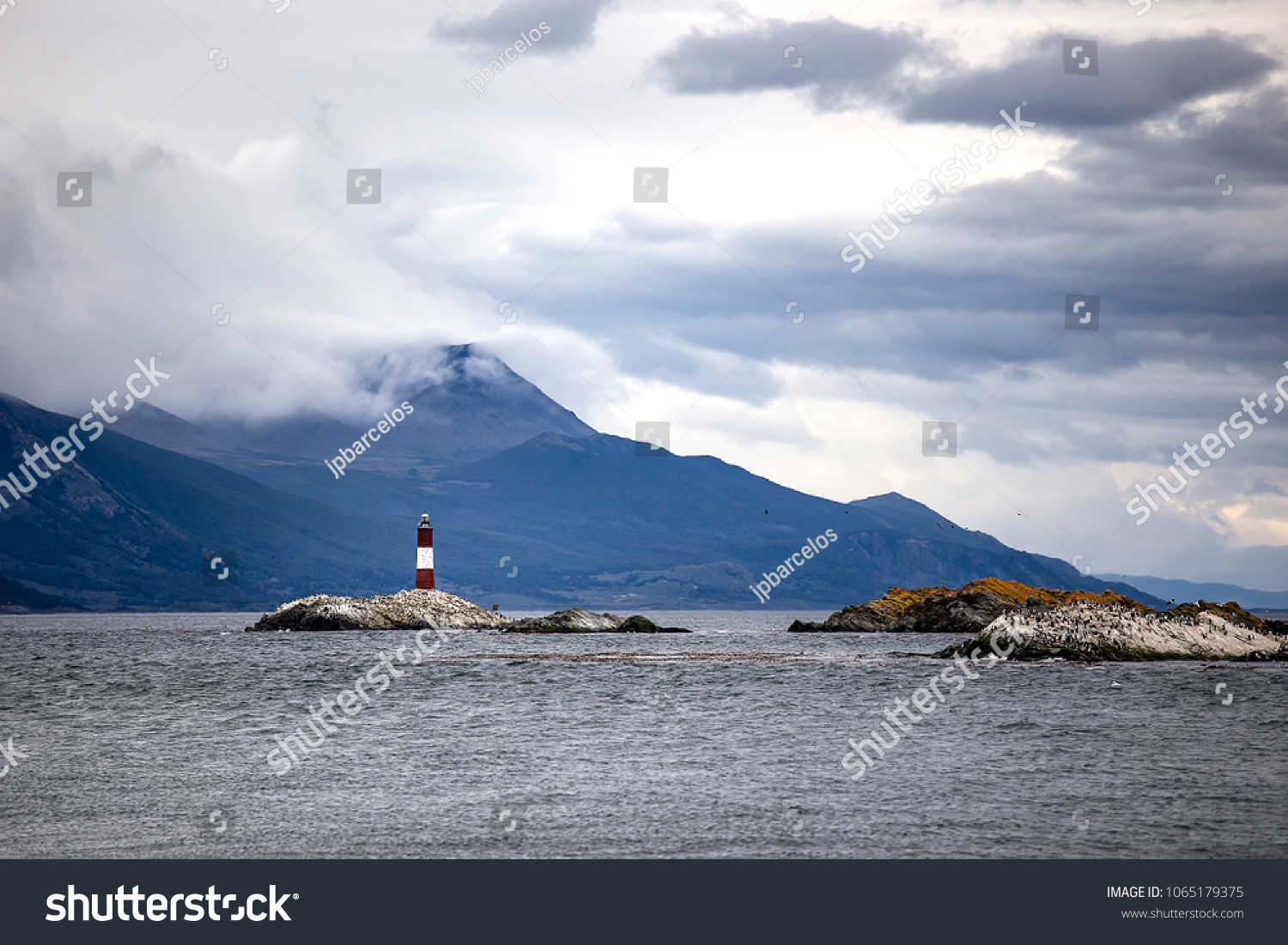 Farol Les Eclaireurs  a red and white striped lighthouse on rocky island on the Beagle Channel  Ushiaia  Argentina