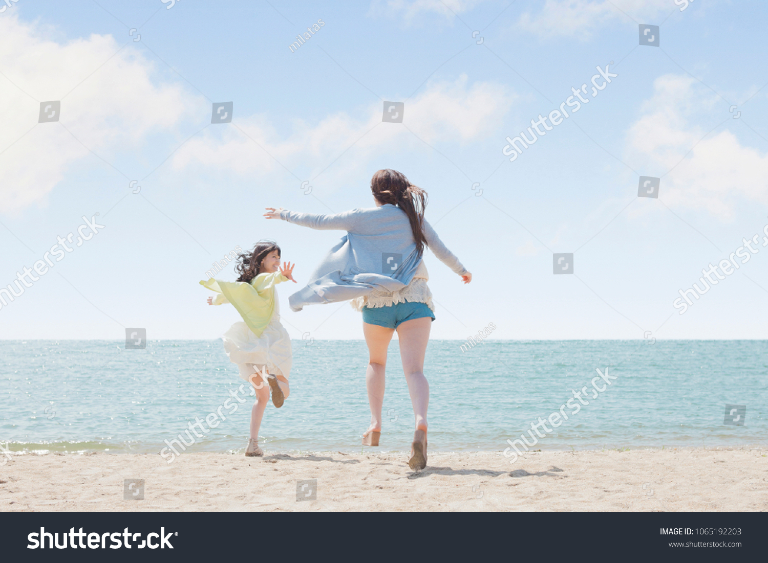 Japanese girls play on the beach