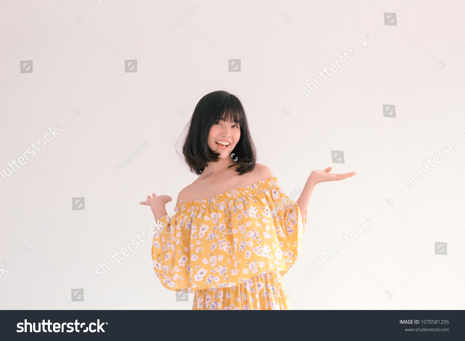 Fashion Portrait of Young cute asian woman wearing vintage Yellow Floral dress