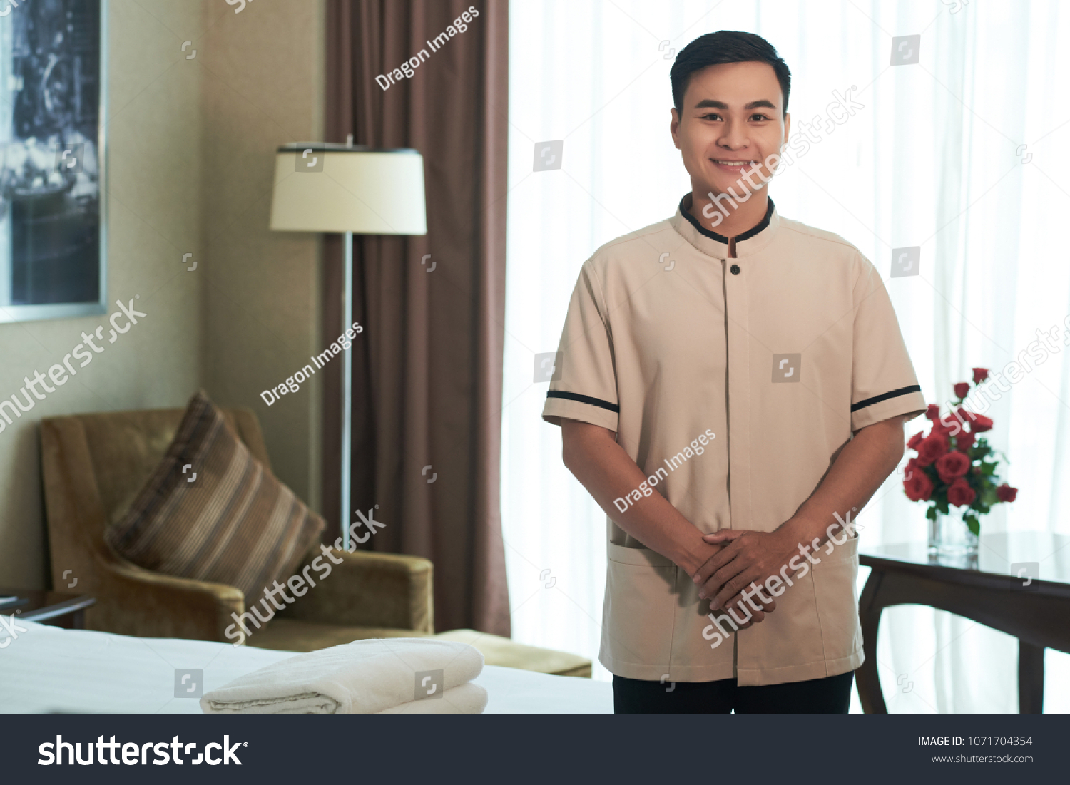 Smiling Vietnamese porter in hotel room
