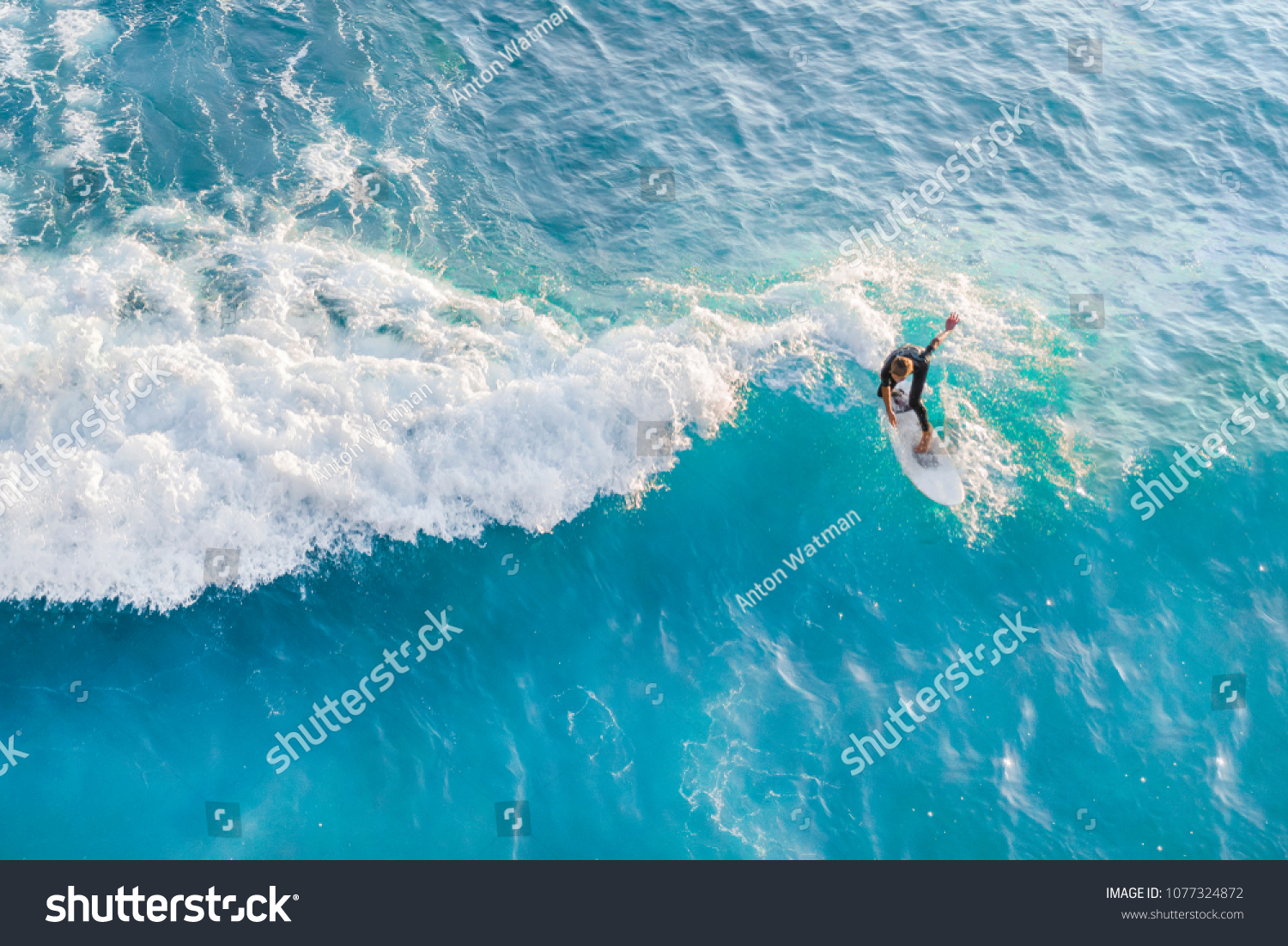 Surfer at the top of the wave in the ocean  top view