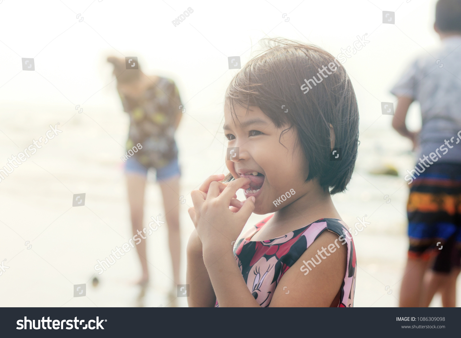 Asian girls are stand at the sea.