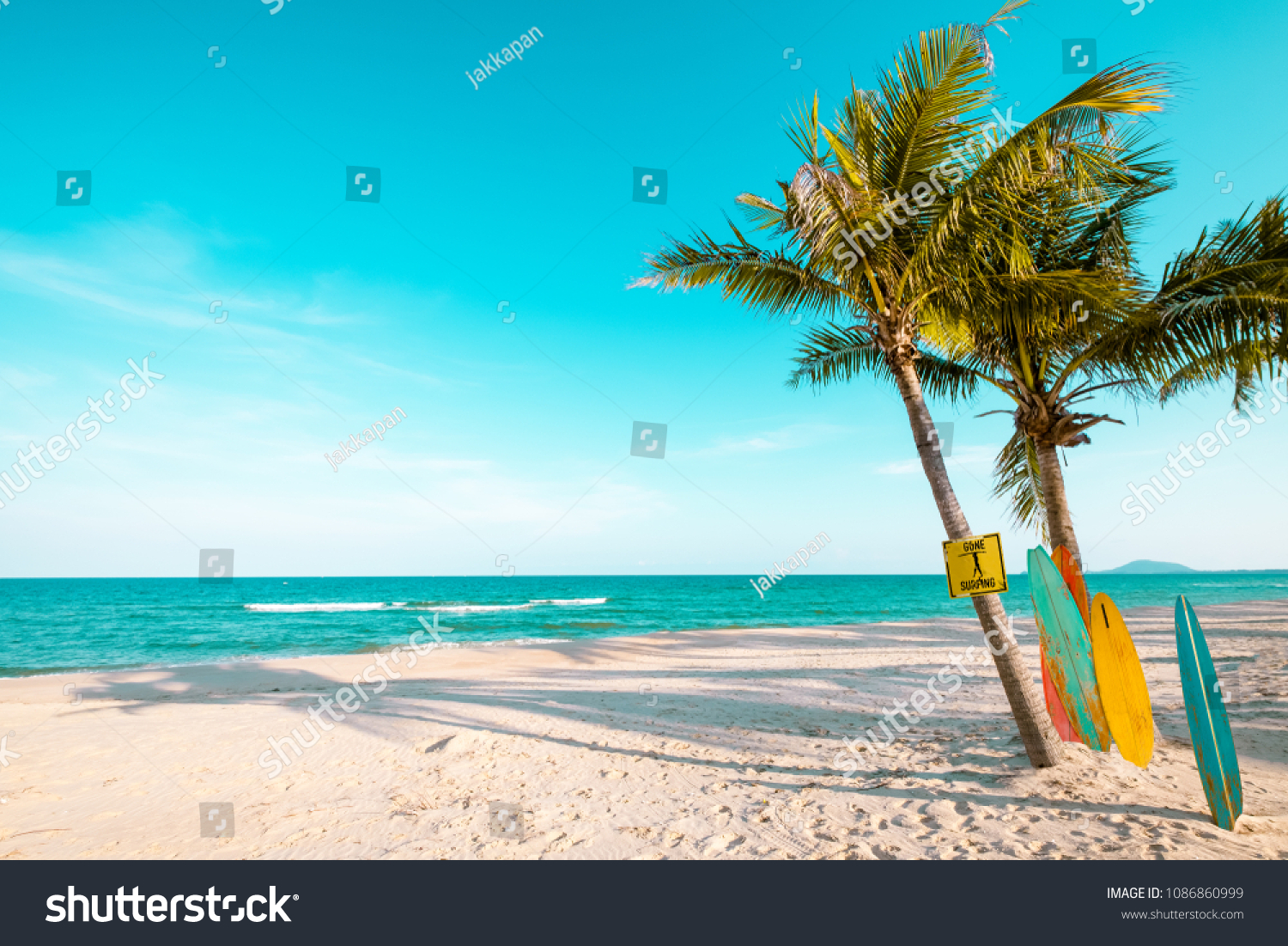 Vintage surf board with palm tree on tropical beach in summer. vintage color tone