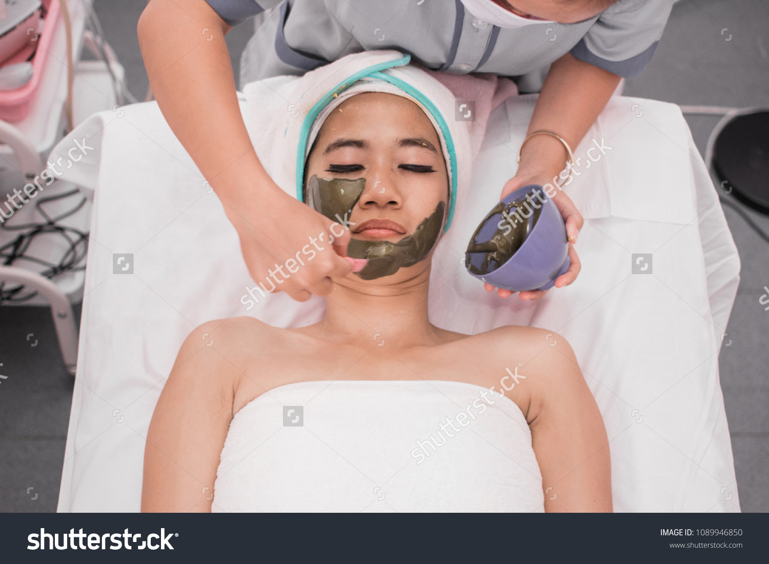 spa beauty treatment skincare. Woman getting facial nourishing mask by beautician at spa salon