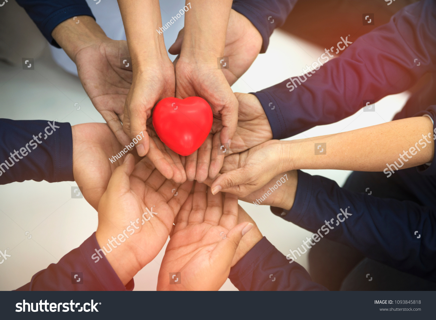Group of hands holding red heart  health care  love  organ donation  family insurance and CSR concept