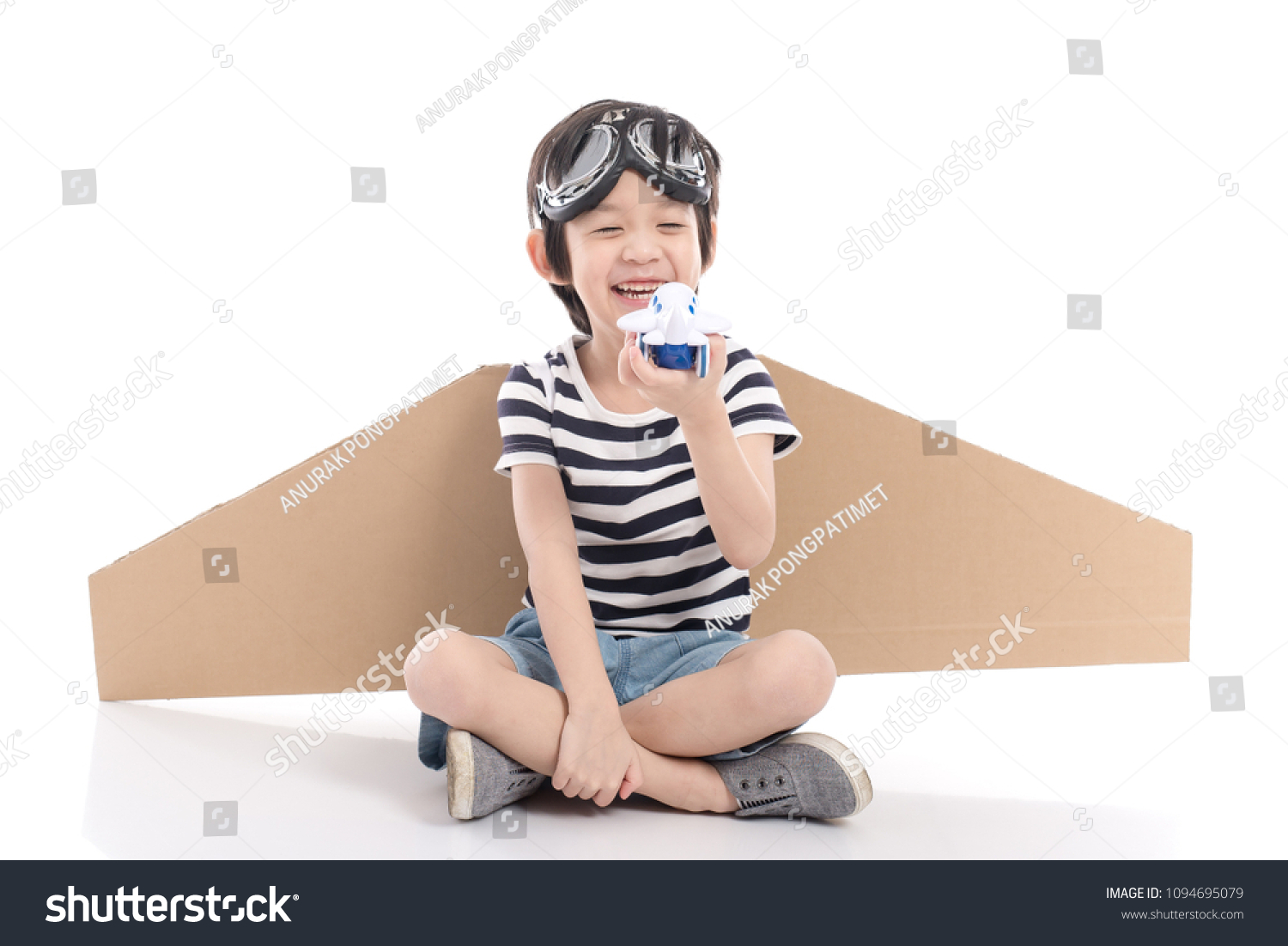 Cute asian child wearing aviator costume on white background isolated