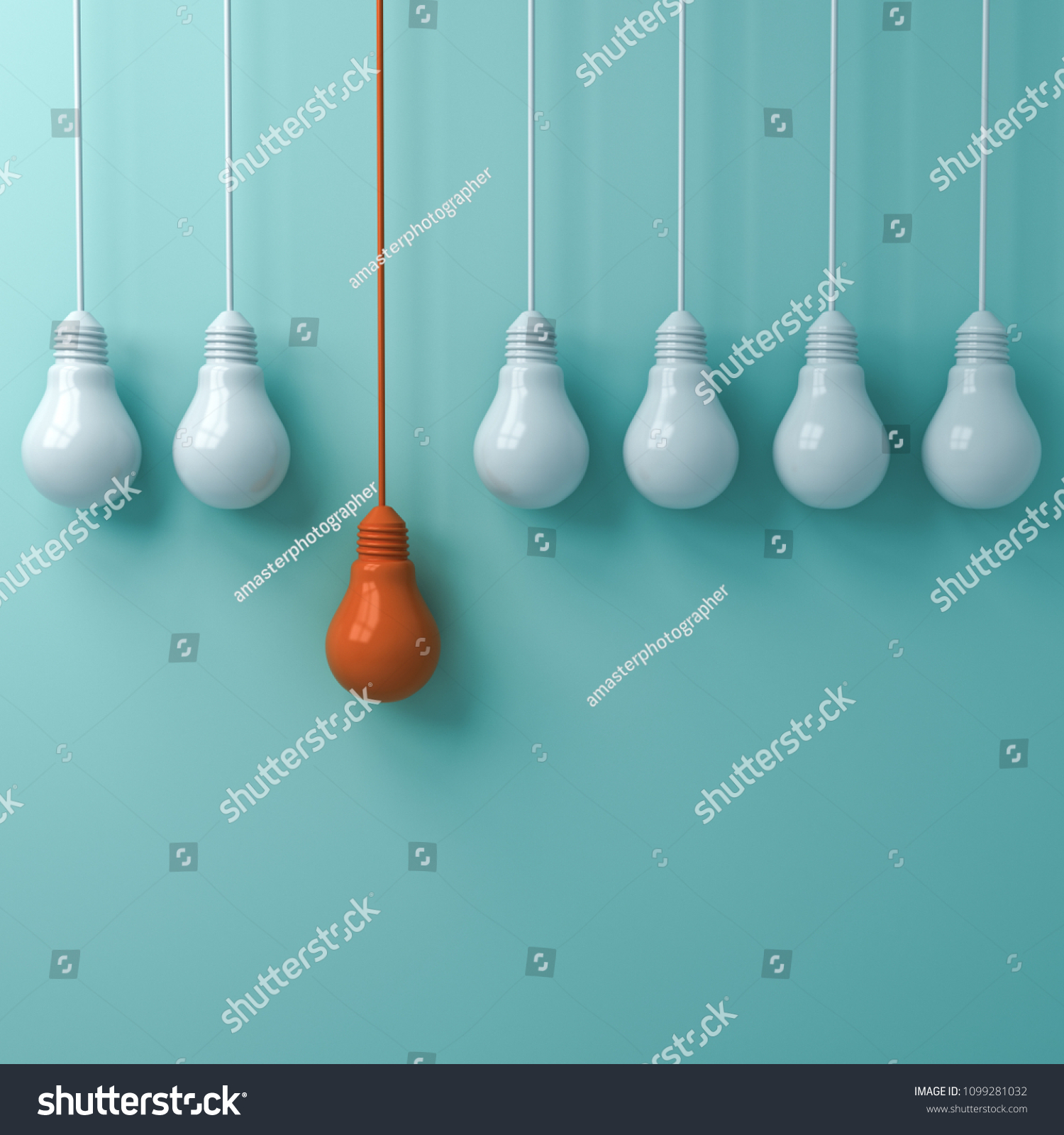 thinkdifferentconceptonehangingorangelightbulbstandingoutfromthe