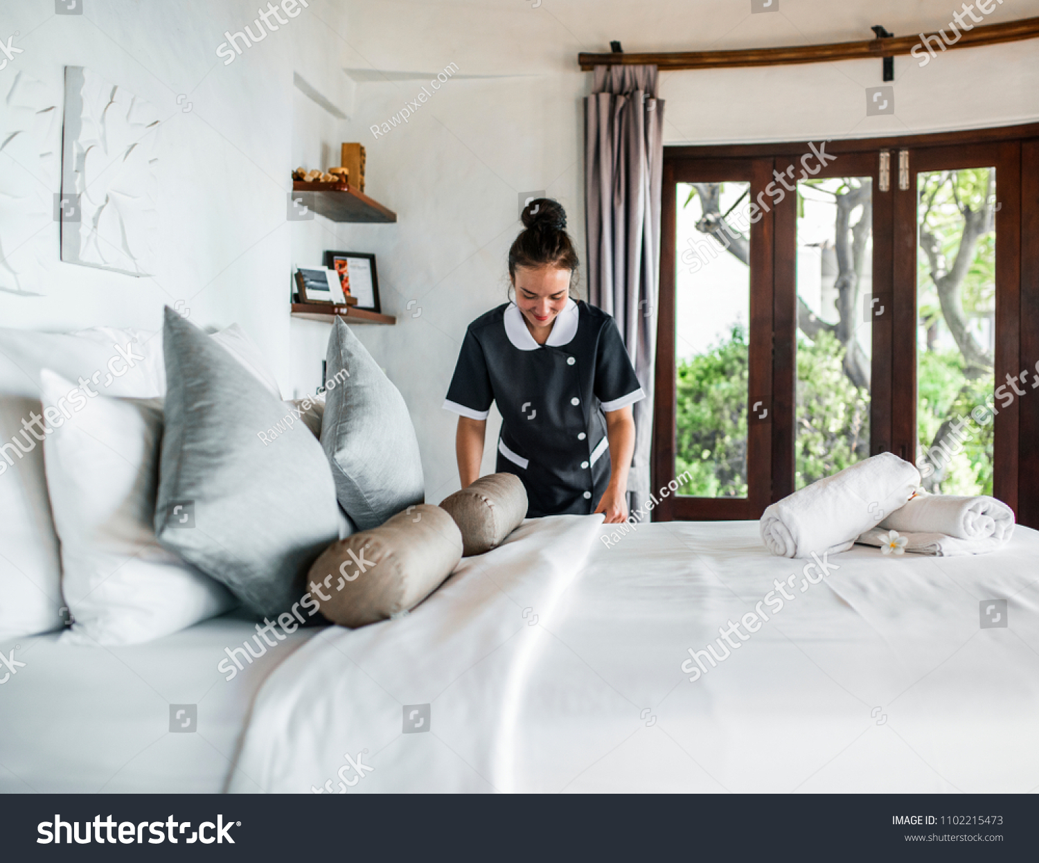 Housekeeper cleaning a hotel room