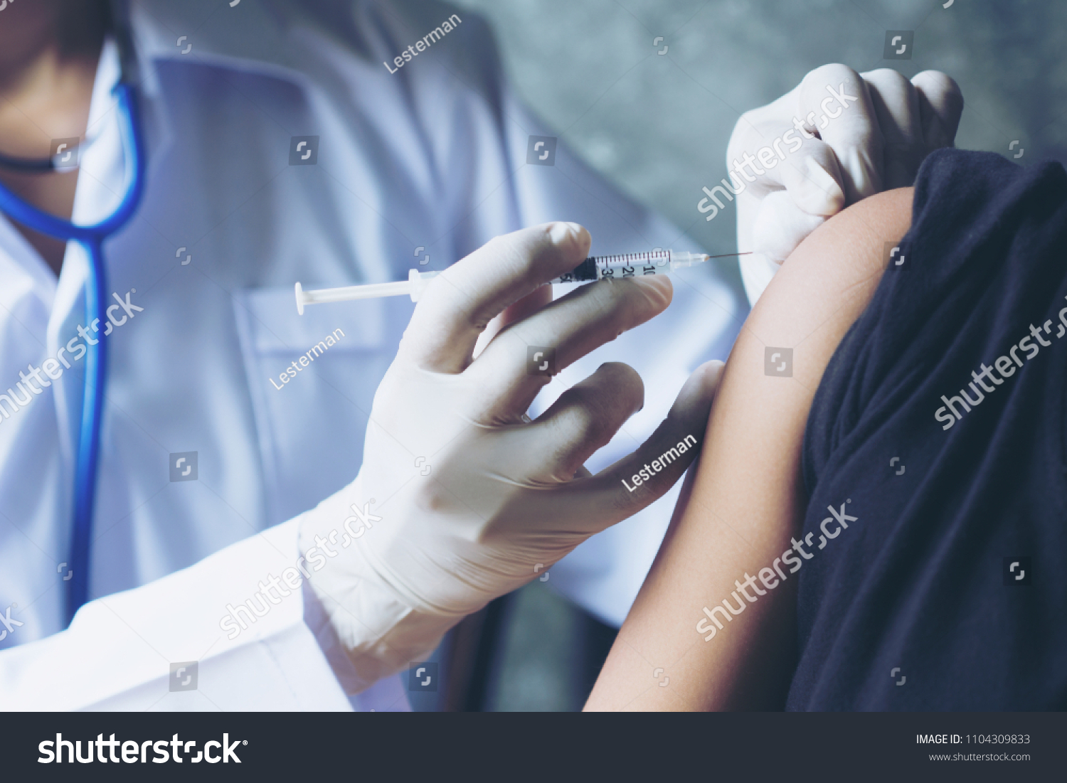 Selective focus Doctor inject vaccine to patient.