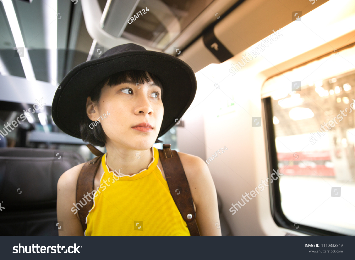 Young woman sitting on the train. Travelling to her destination alone.