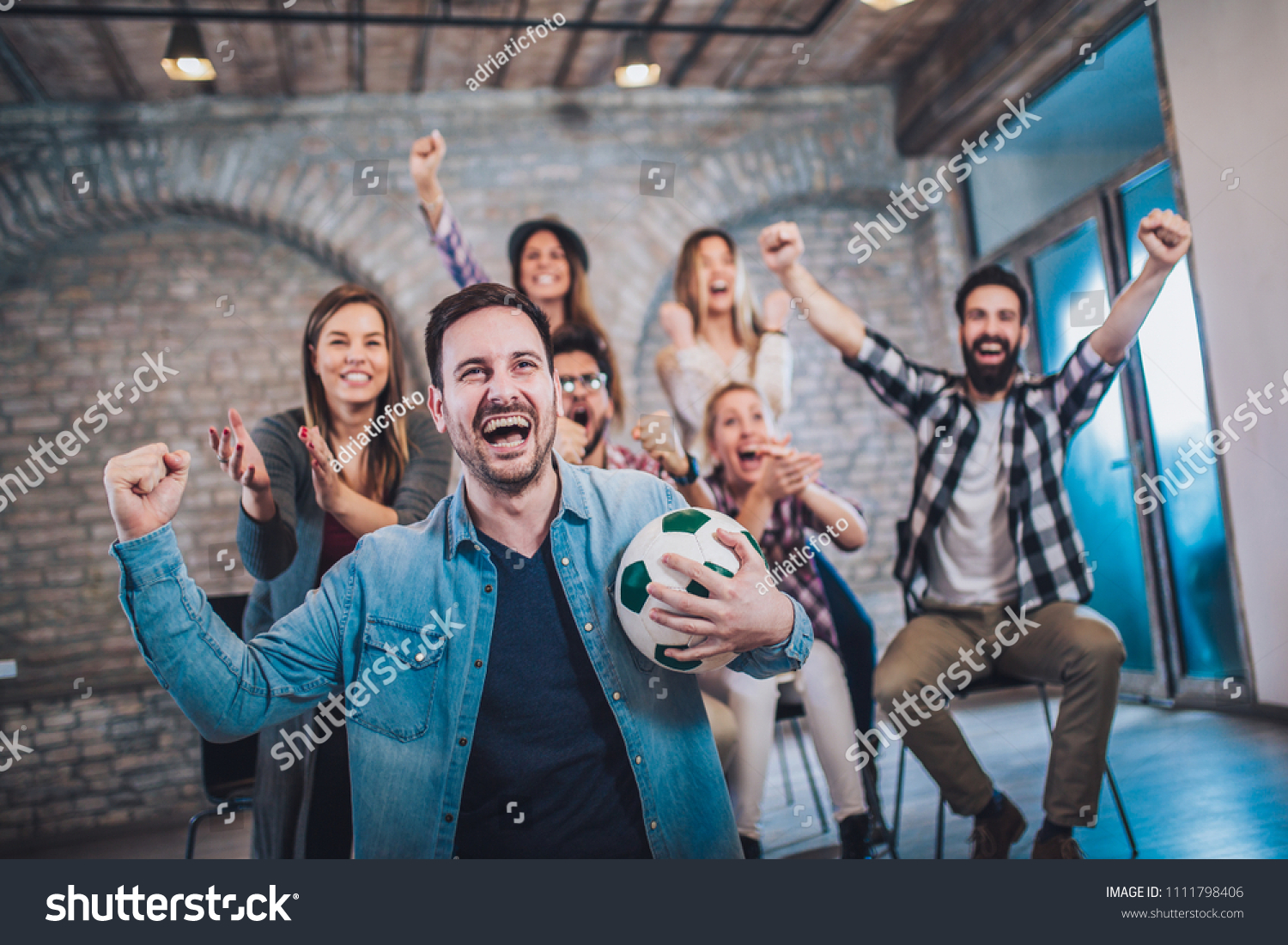 Happy friends or football fans watching soccer on tv and celebrating victory. Friendship sports and entertainment concept.
