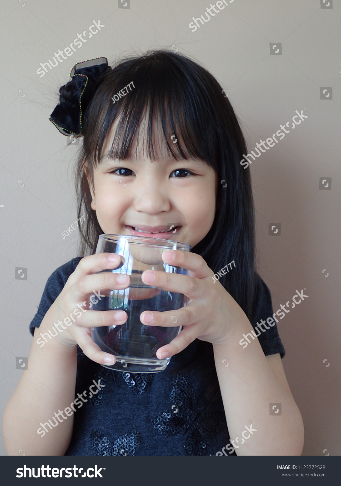 Little asian girl drink water 