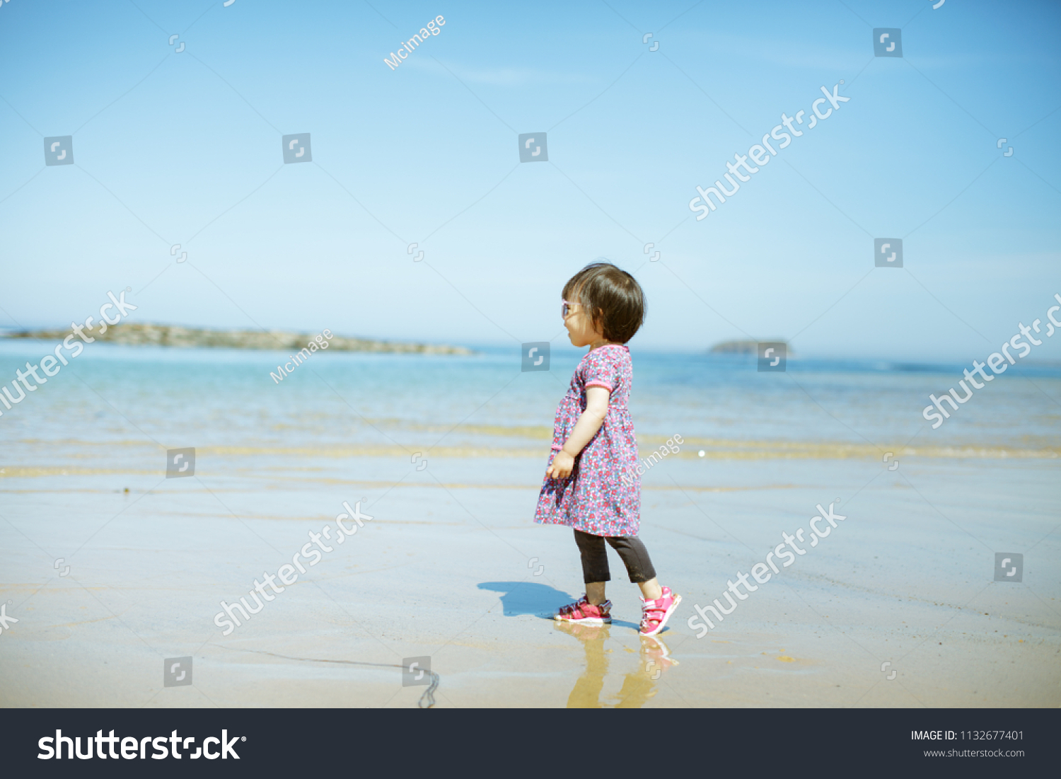 baby girl playing at summer beach