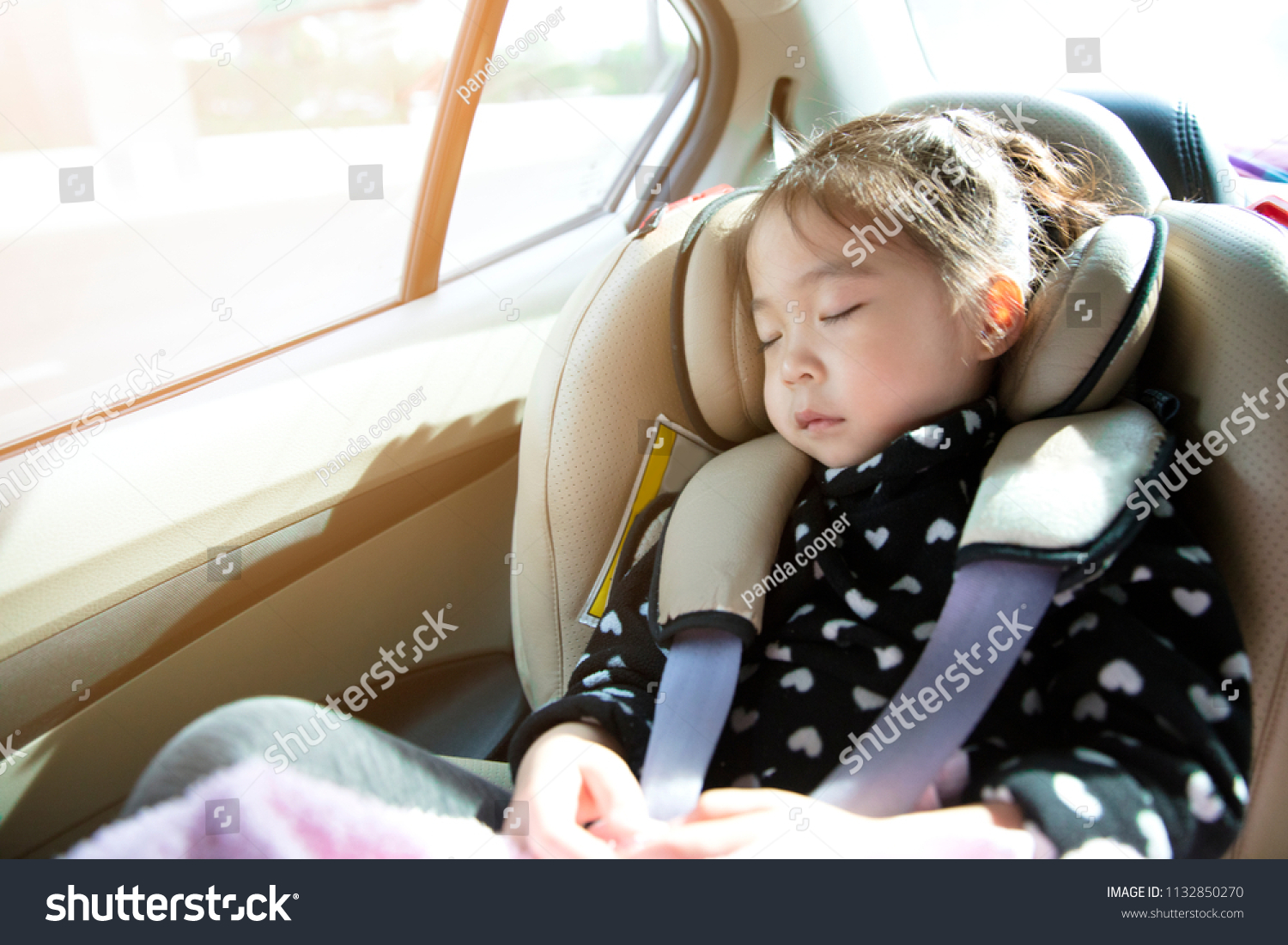 Asian little girl sleeping in car with car seat