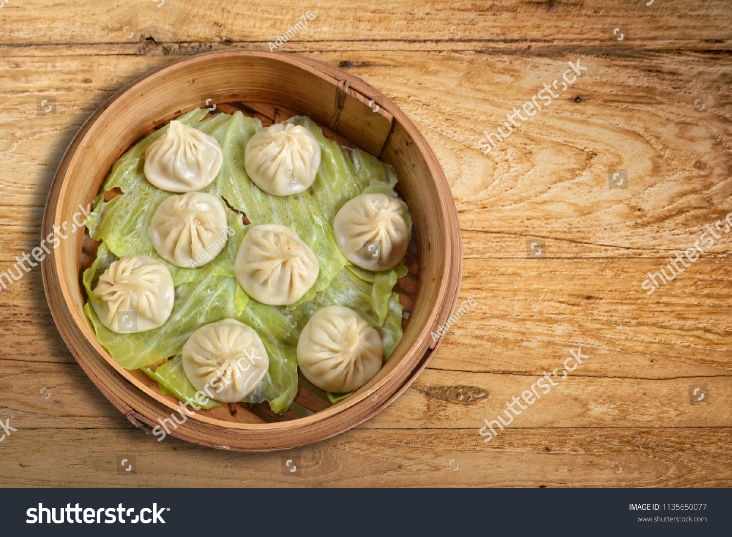 Xiao Long Bao is dim sum one of China. Shanghai popular food made from wheat flour. wrap Pork chops are served with broth. It comes from jelly the pork skin steamed bun in small Bamboo tray on wooden