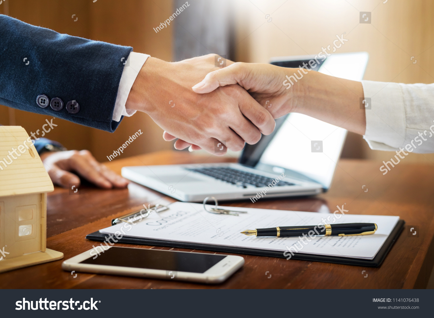 House developers agent or financial advisor and customers shaking hands after signing document making deal as successful agreement contract with a firm