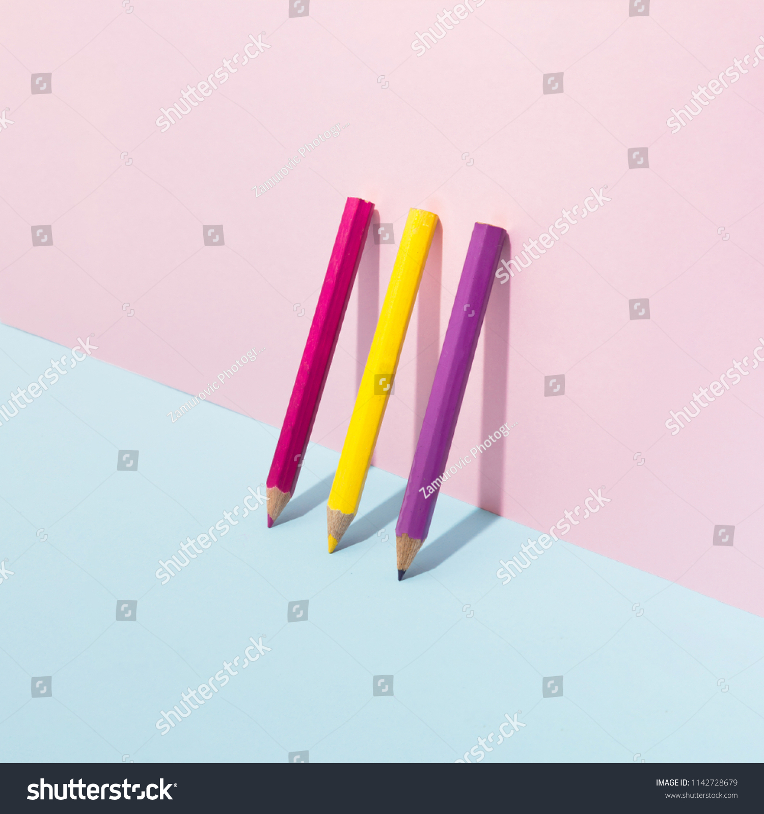 School color pencils on pastel background. Minimal concept art.