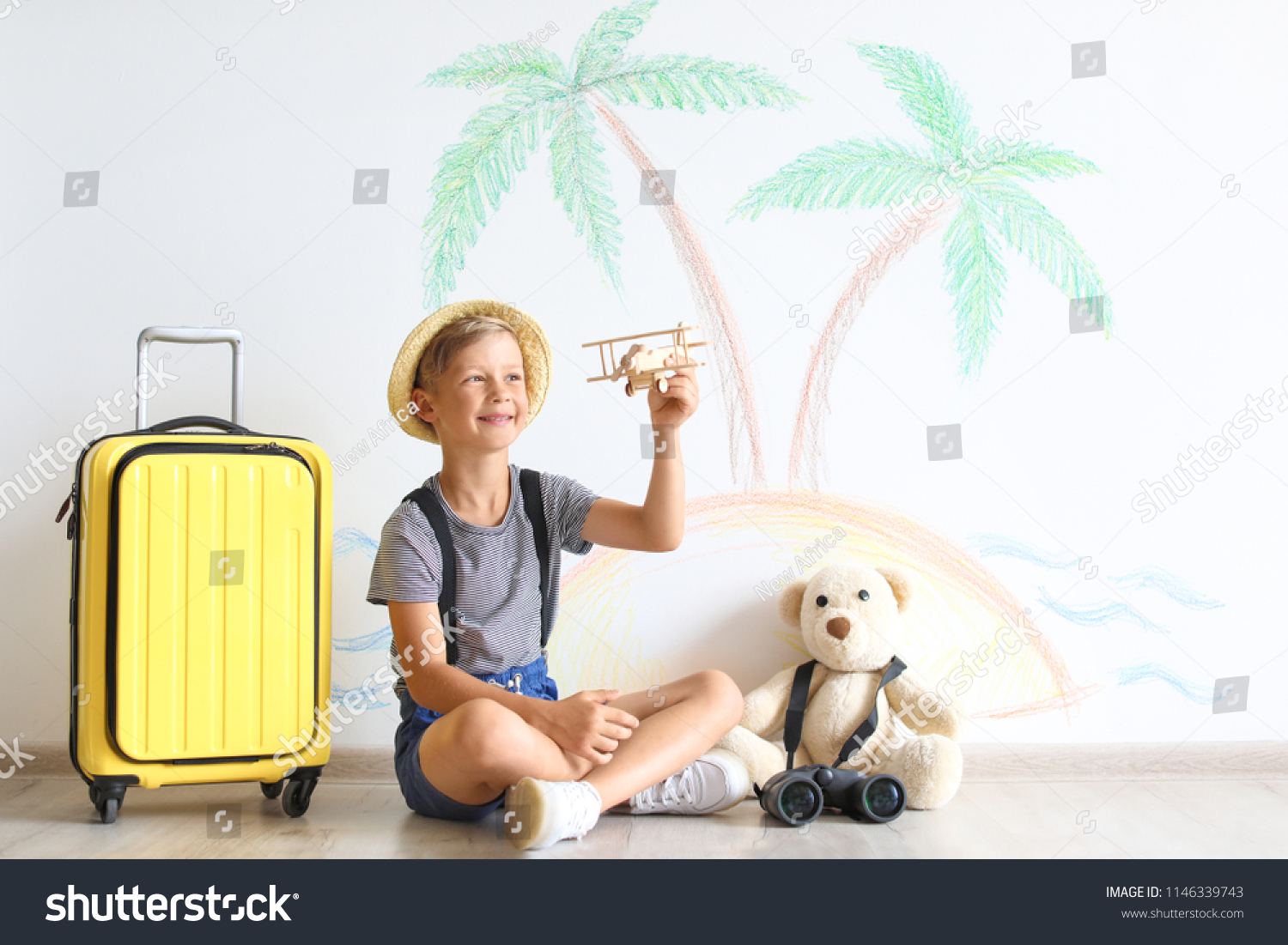 Adorable little child playing with toy airplane indoors