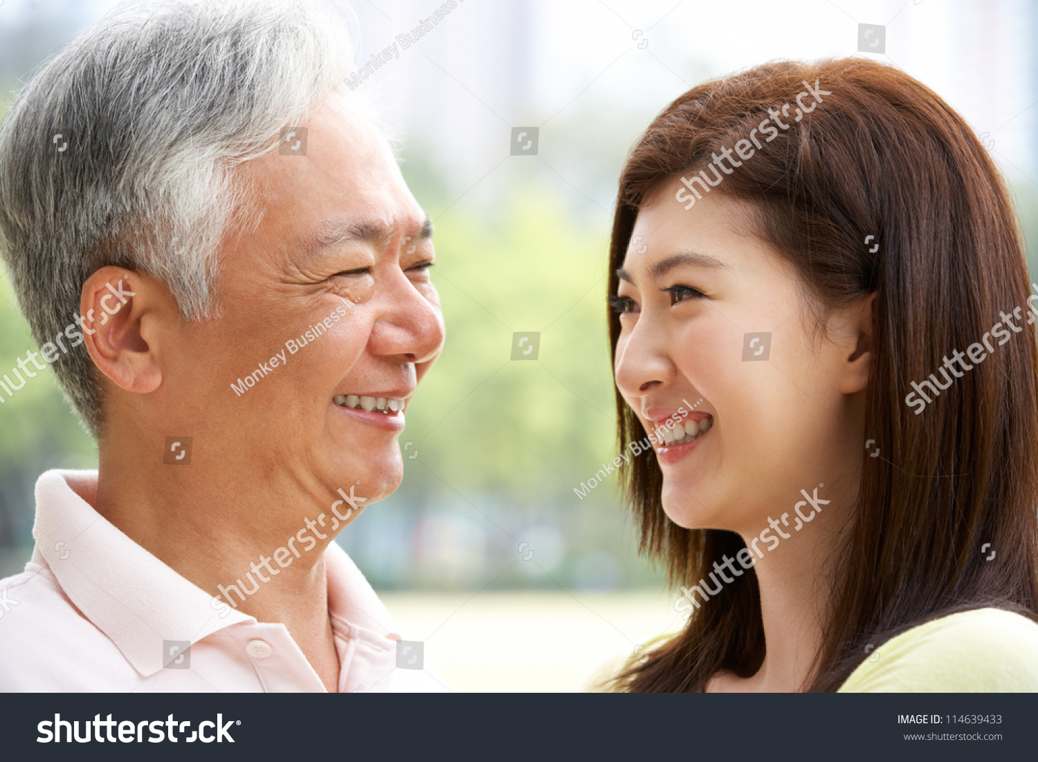 Portrait Of Chinese Father With Adult Daughter In Park