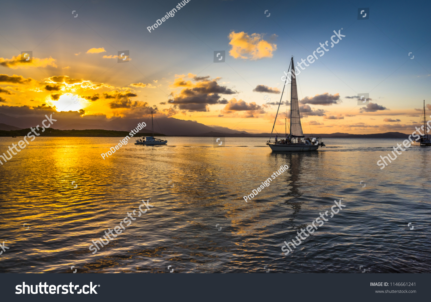 afternoon sunset cloudburst Coral sea Port Douglas Queensland calm ocean reflections Daintree background