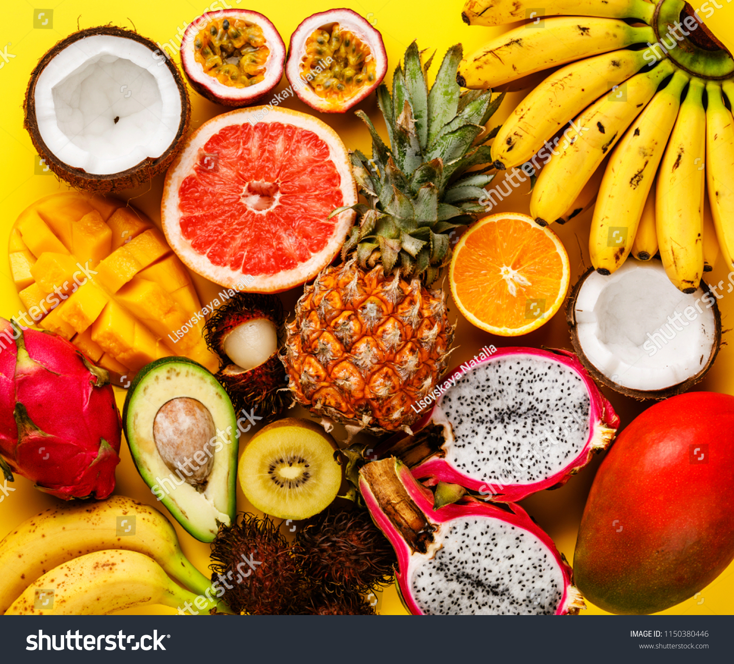 Tropical exotic fruits assorted Pineapple Coconut Pitahaya Kiwi Banana Mango Orange Avocado Passion Fruit on yellow background