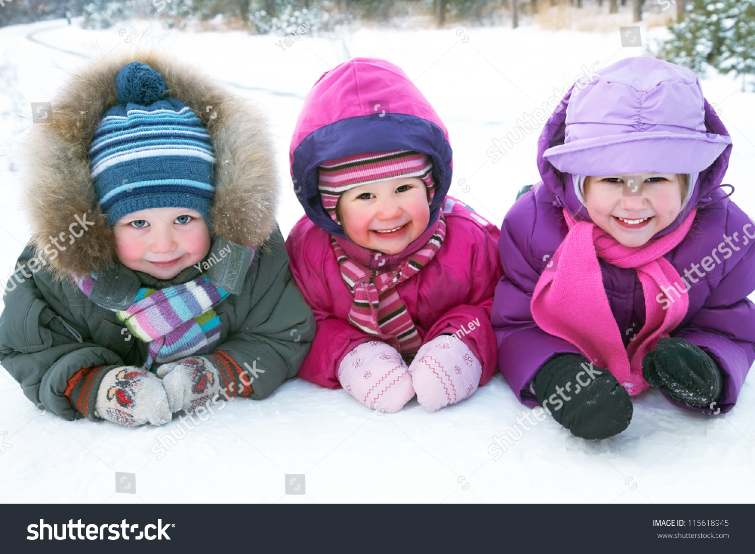 Group of children playing on snow in winter time