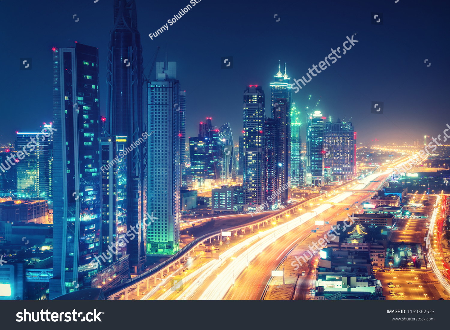 Scenic nighttime skyline of downtown Dubai United Arab Emirates. Aerial view on highways and skyscrapers in the distance.