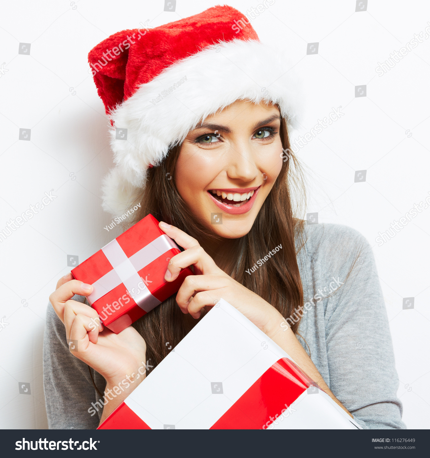 Christmas Santa hat isolated woman portrait hold christmas gift. Smiling happy girl on white background.