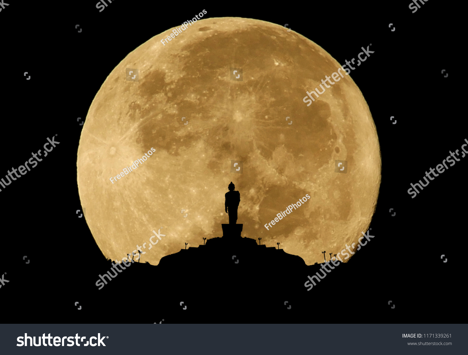 Buddha statue silhouette on full moon background.
