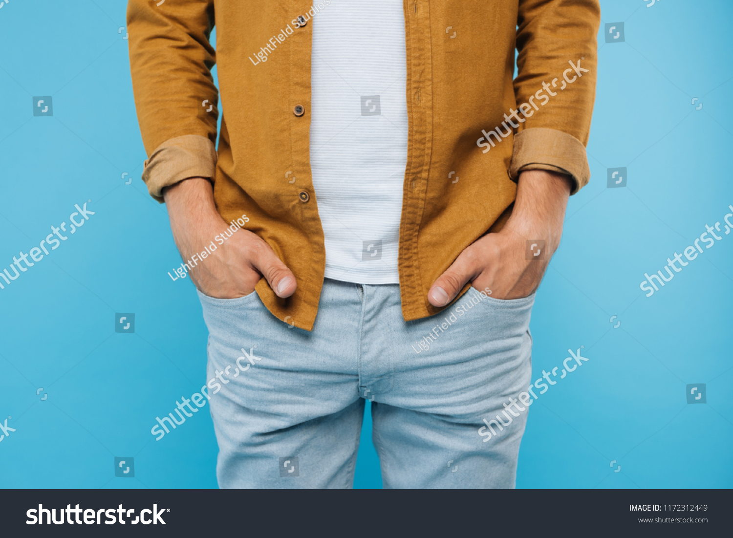 cropped image of man standing with hands in pockets isolated on