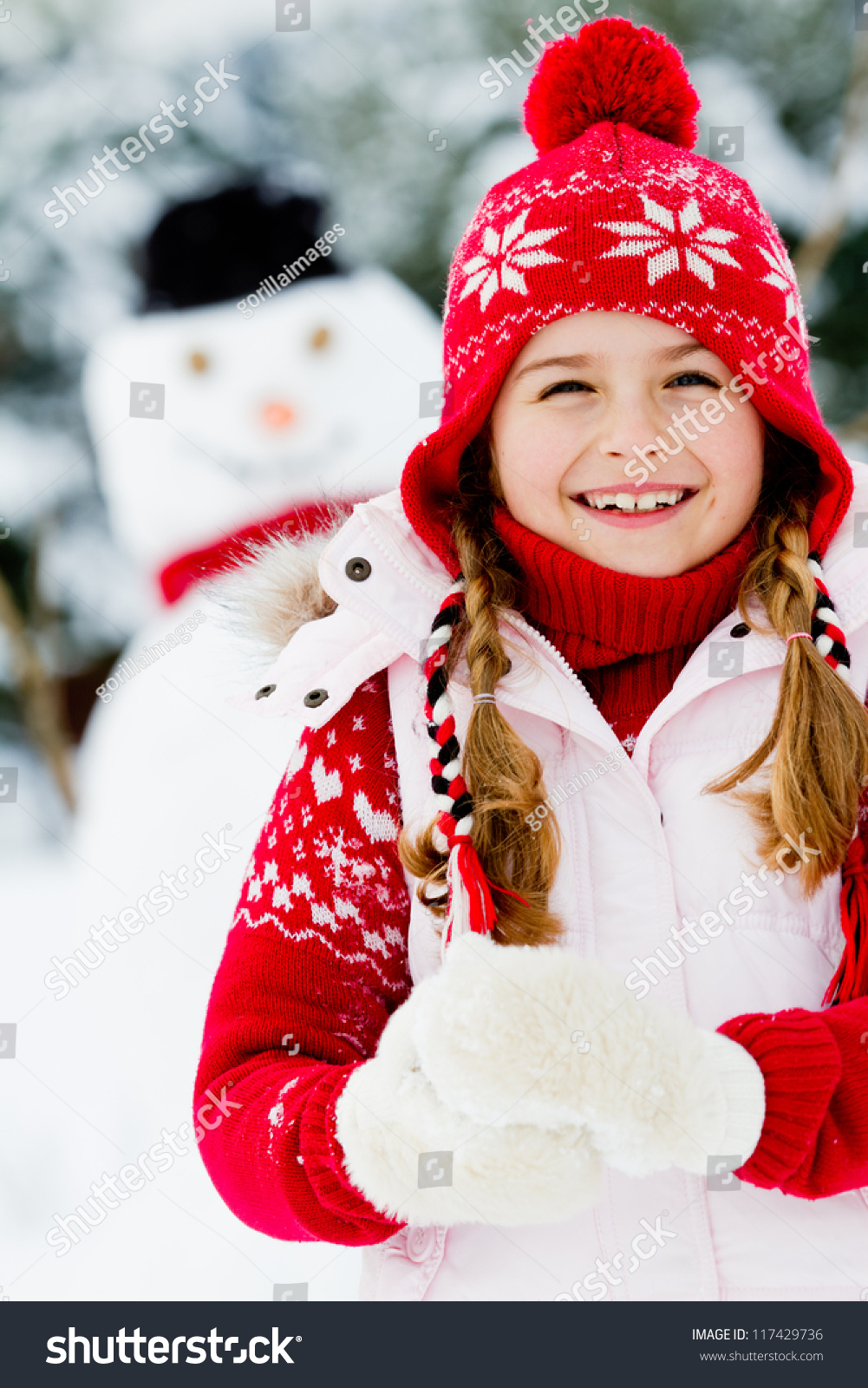 Winter  snowman - lovely girl has a fun in snow