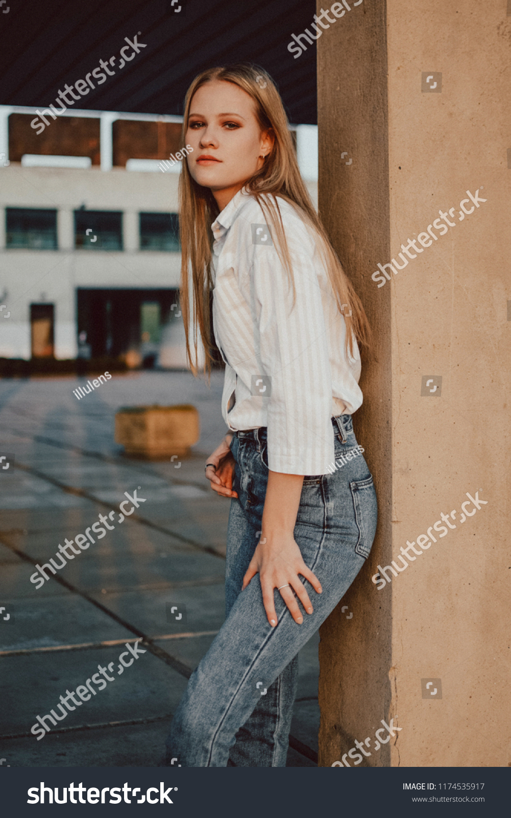 Girl with a brooding look posing among the columns of the USSR building ...