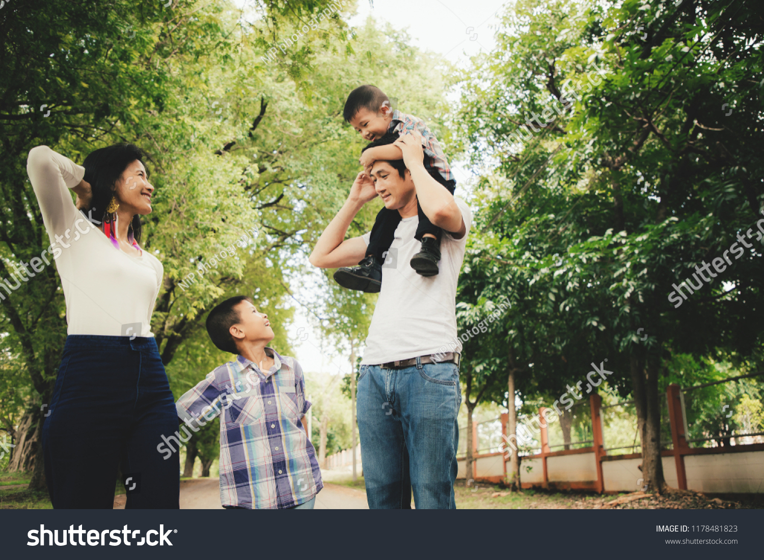 Happy Asian Family enjoying family time together in the park. Family Concept