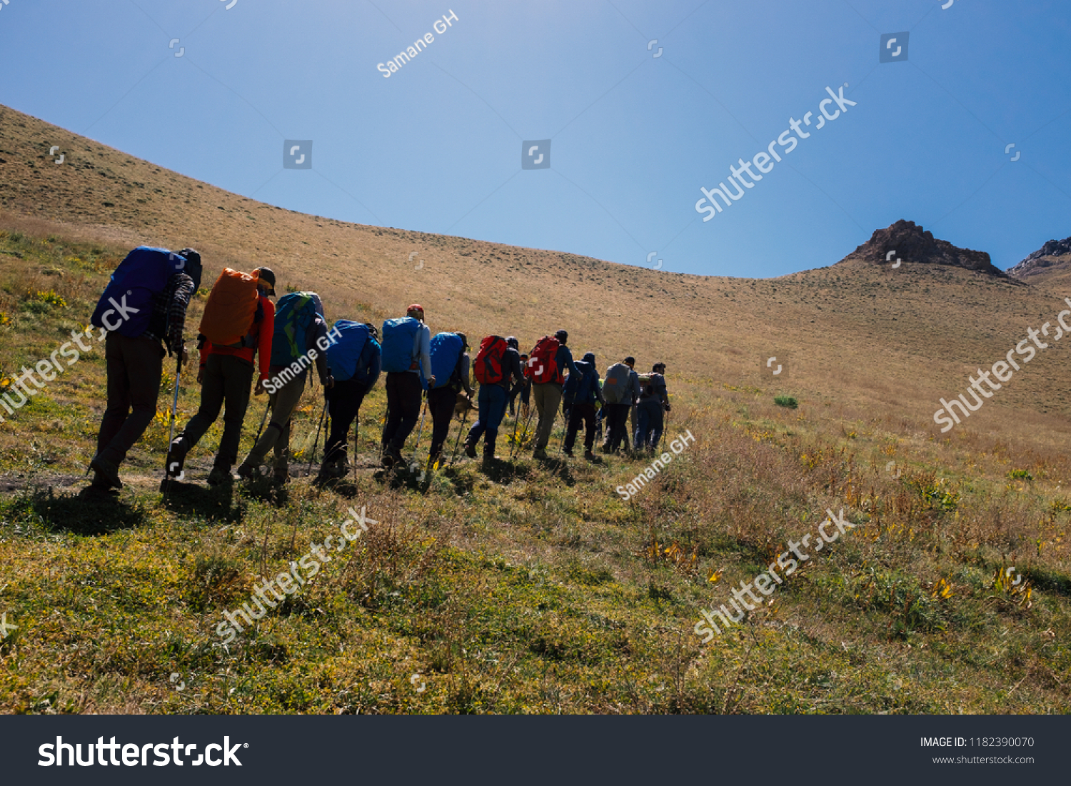 A group of climbers is going to the summit. Teamwork and sports theme.