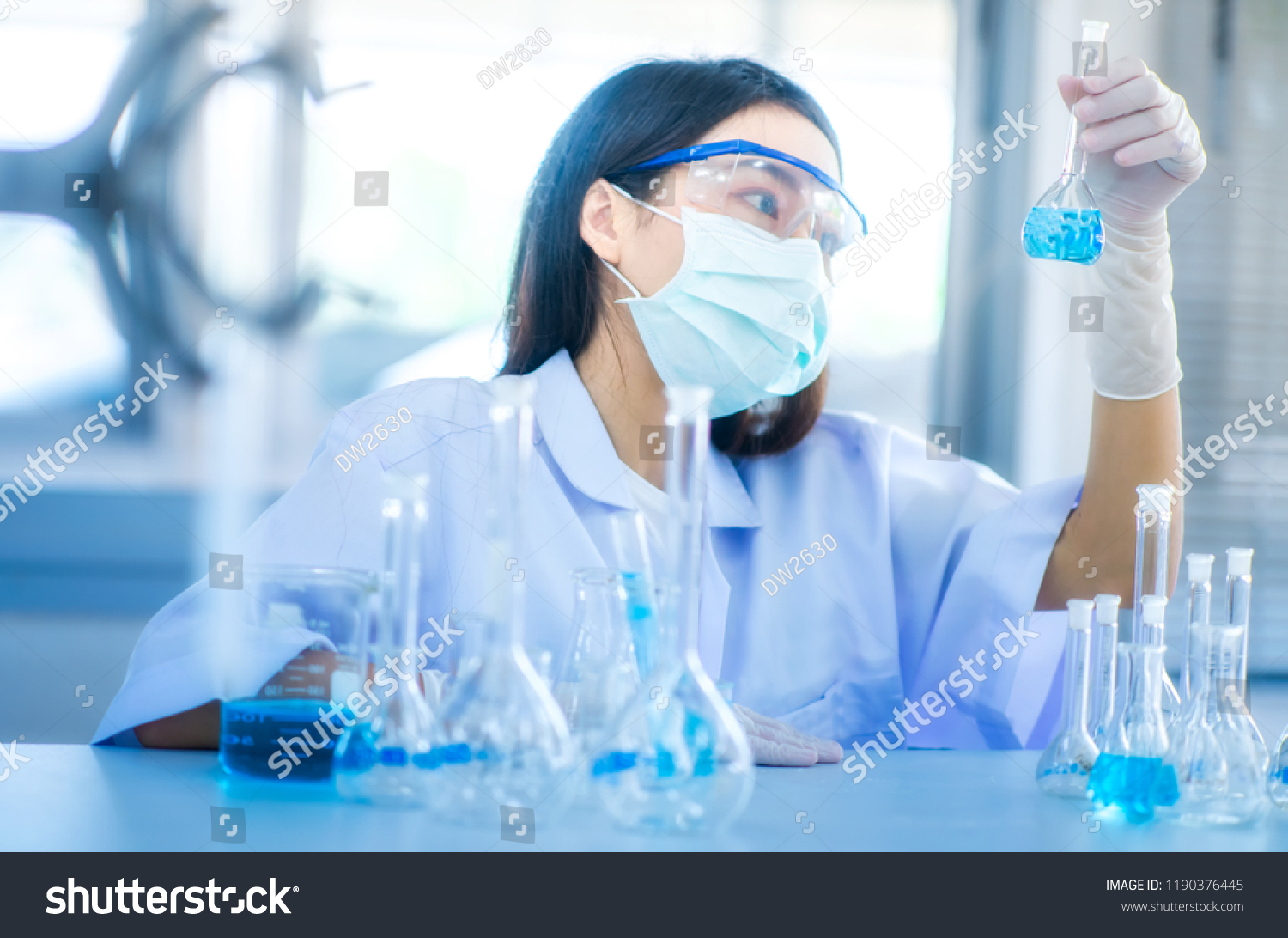 Professional distinguished Science specialist at work.Young Asian scientist with test tube making research in clinical laboratory.Innovative technologies in science and medicine
