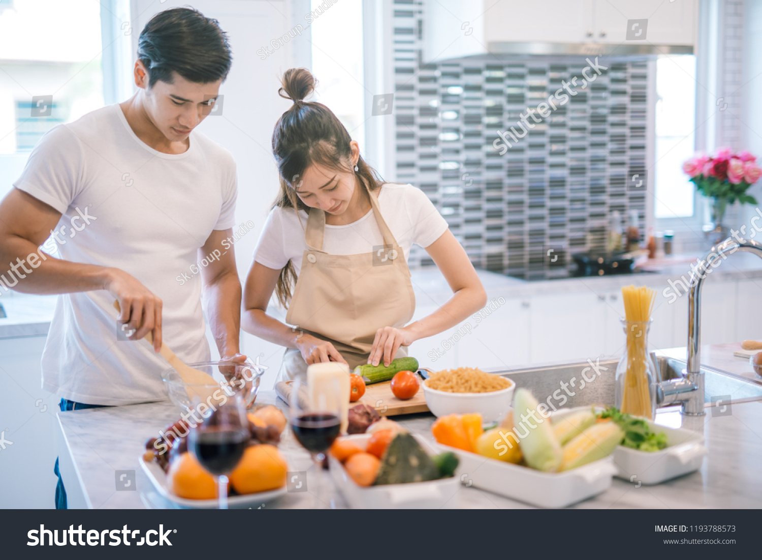 young asian couple cooking together in the kitchen at home.