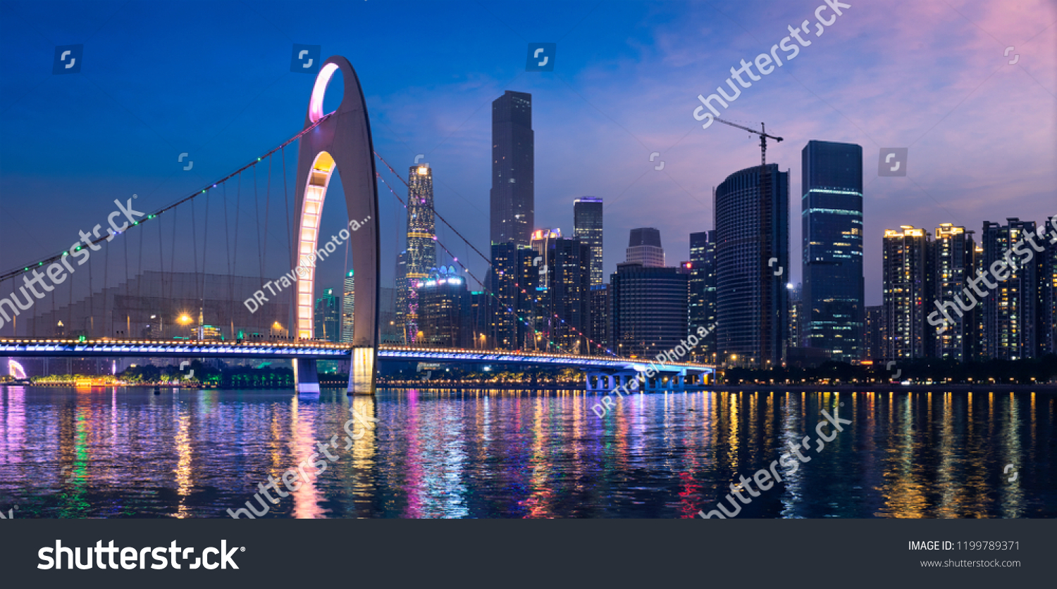 Guangzhou cityscape skyline over the Pearl River illuminated in the evening panorama. Guangzhou China