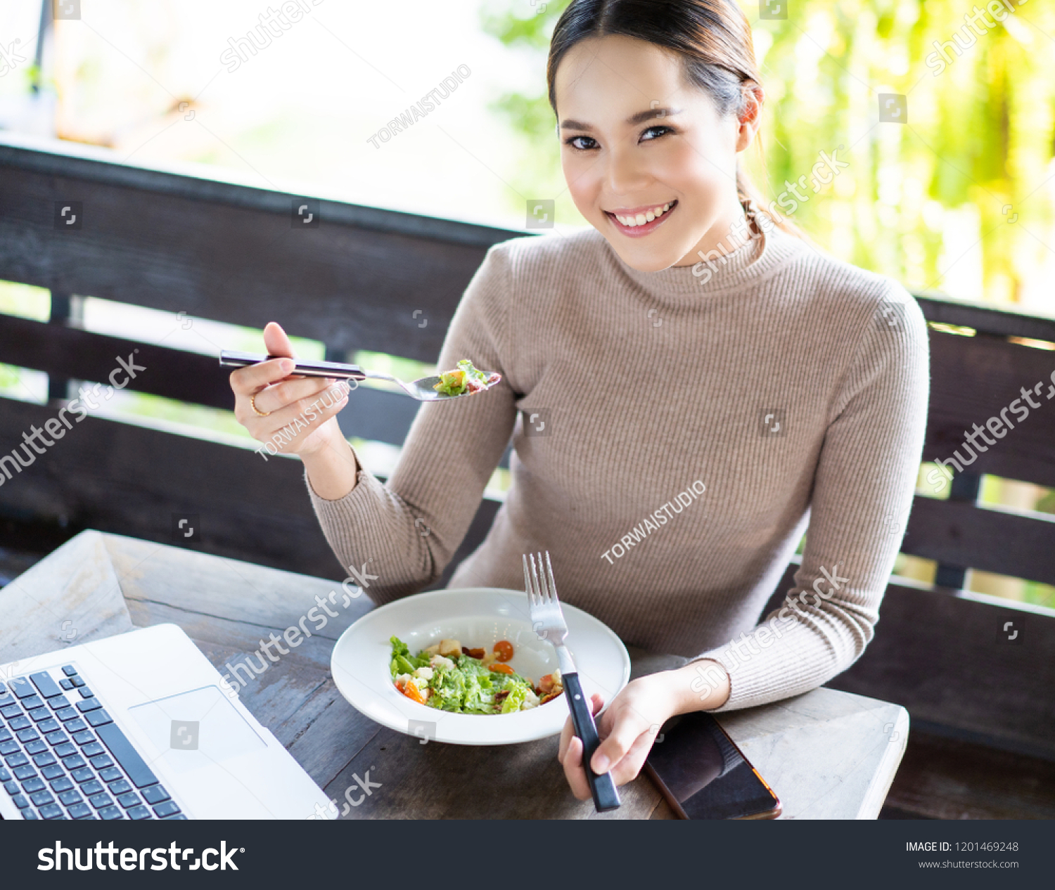 Asian woman are working and eating salads.