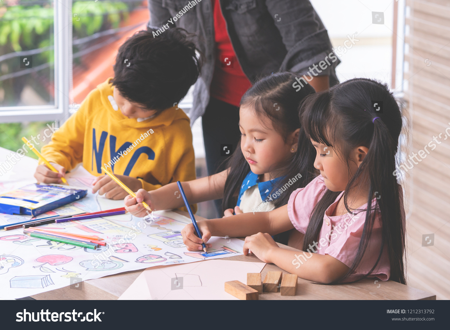Student kids are painting on paper in Art group