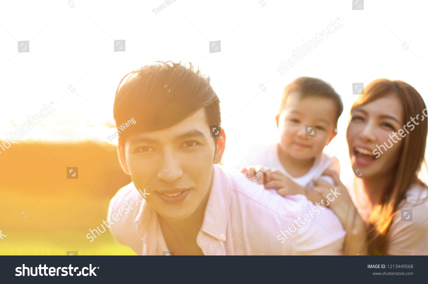 Young family with baby having fun in nature