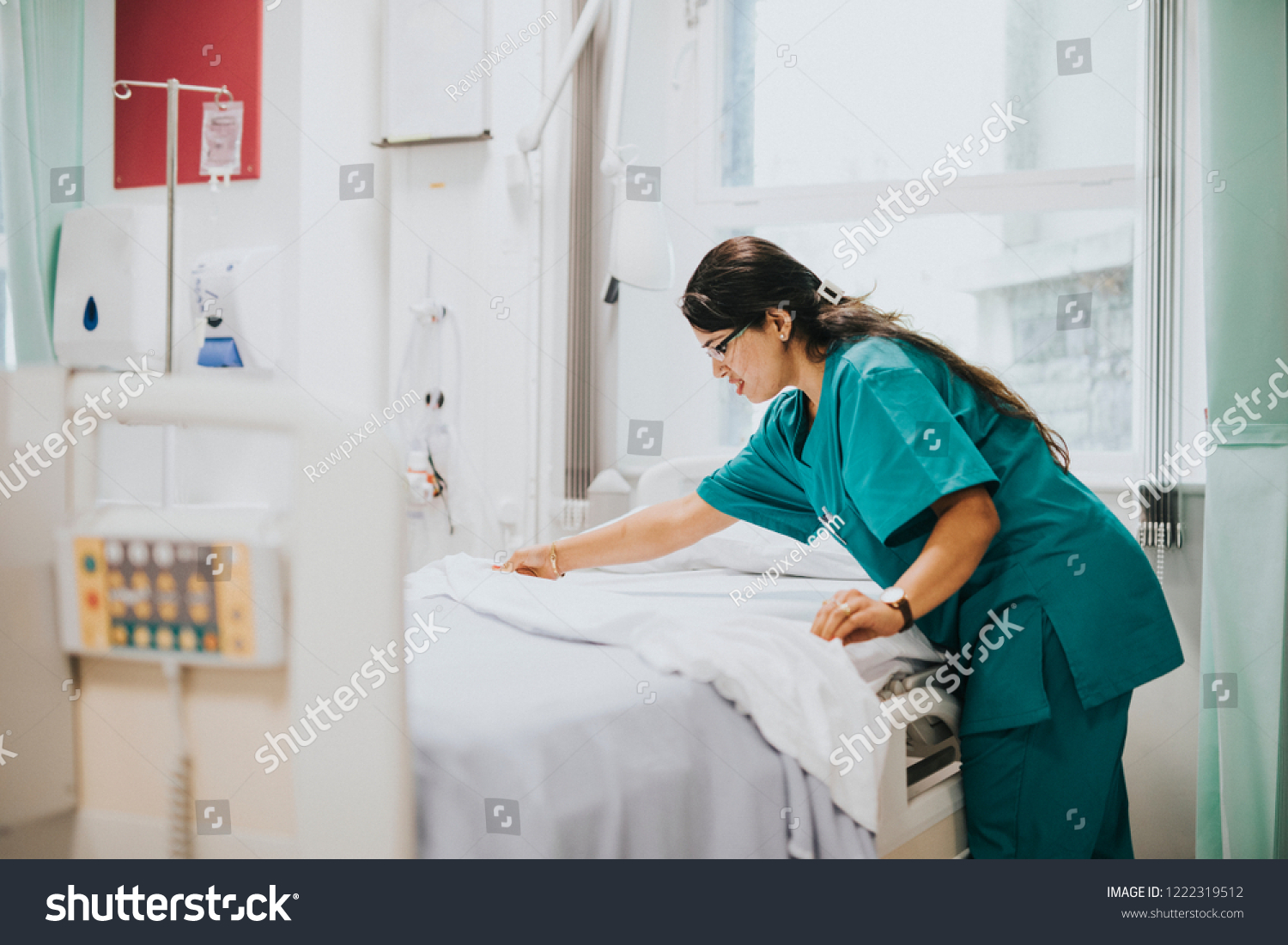 Nurse making the bed at a hospital