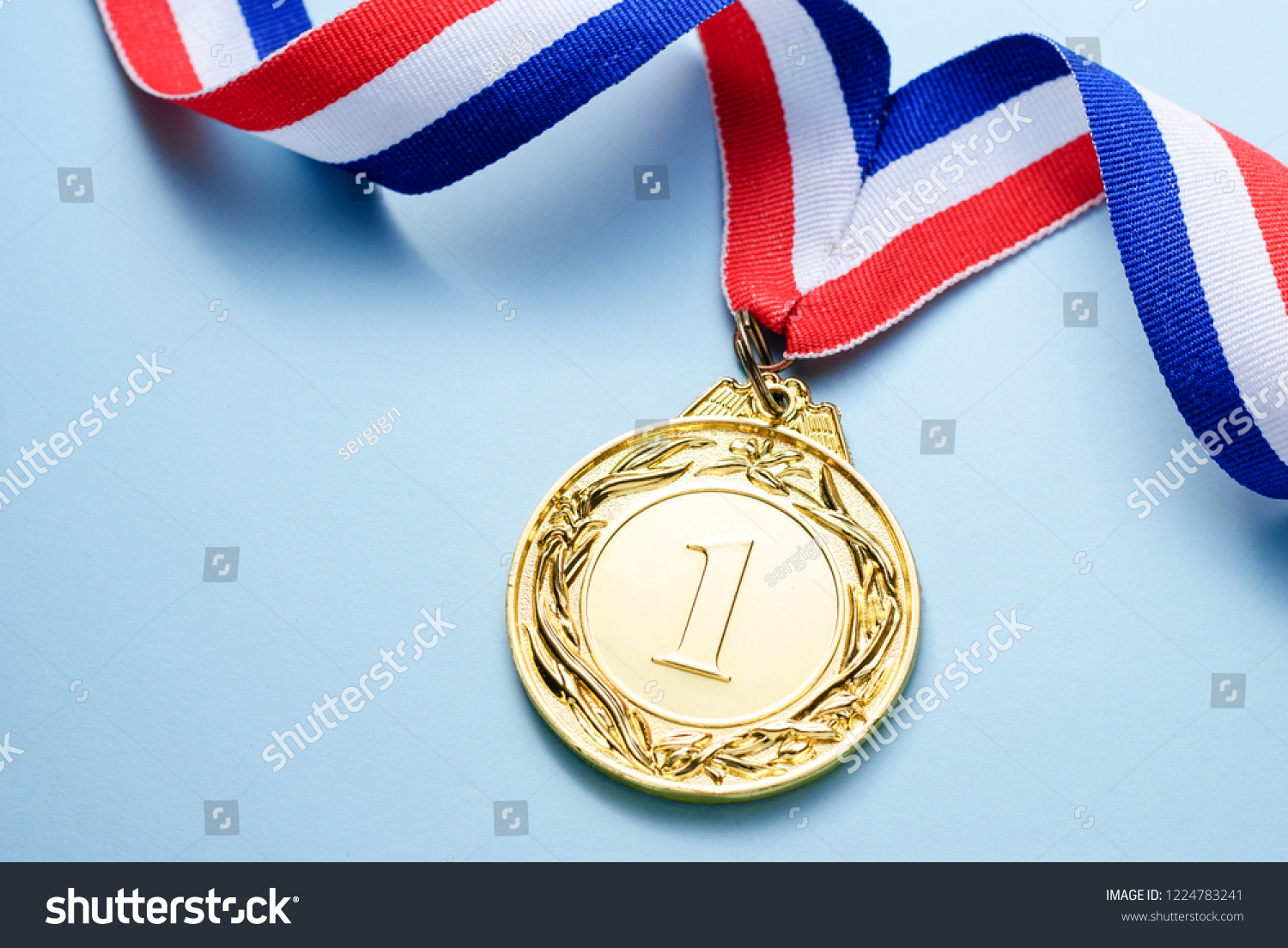 Gold medal 1 place with a ribbon on a light blue background  the concept of victory or success