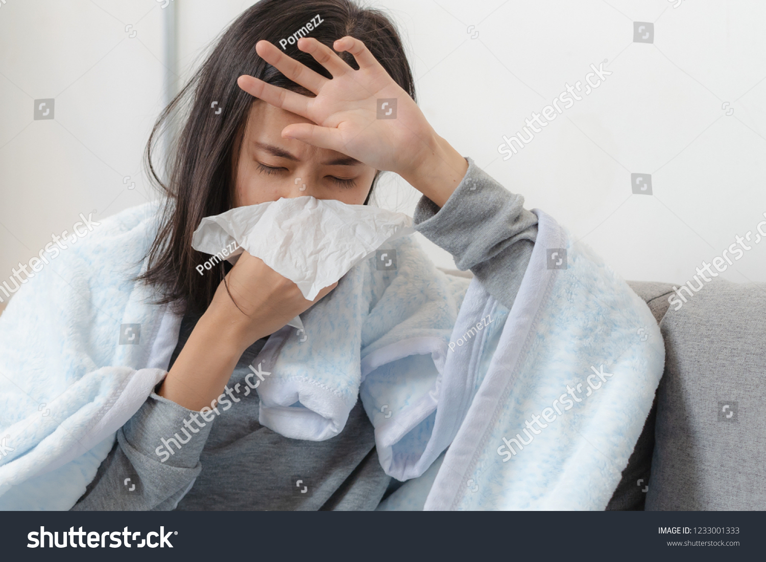 Sick day at home. Asian woman has runny and common cold.