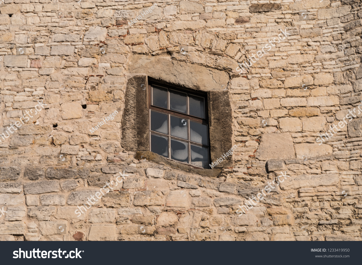 slanted window in an old historic facade - parallelogram shaped window
