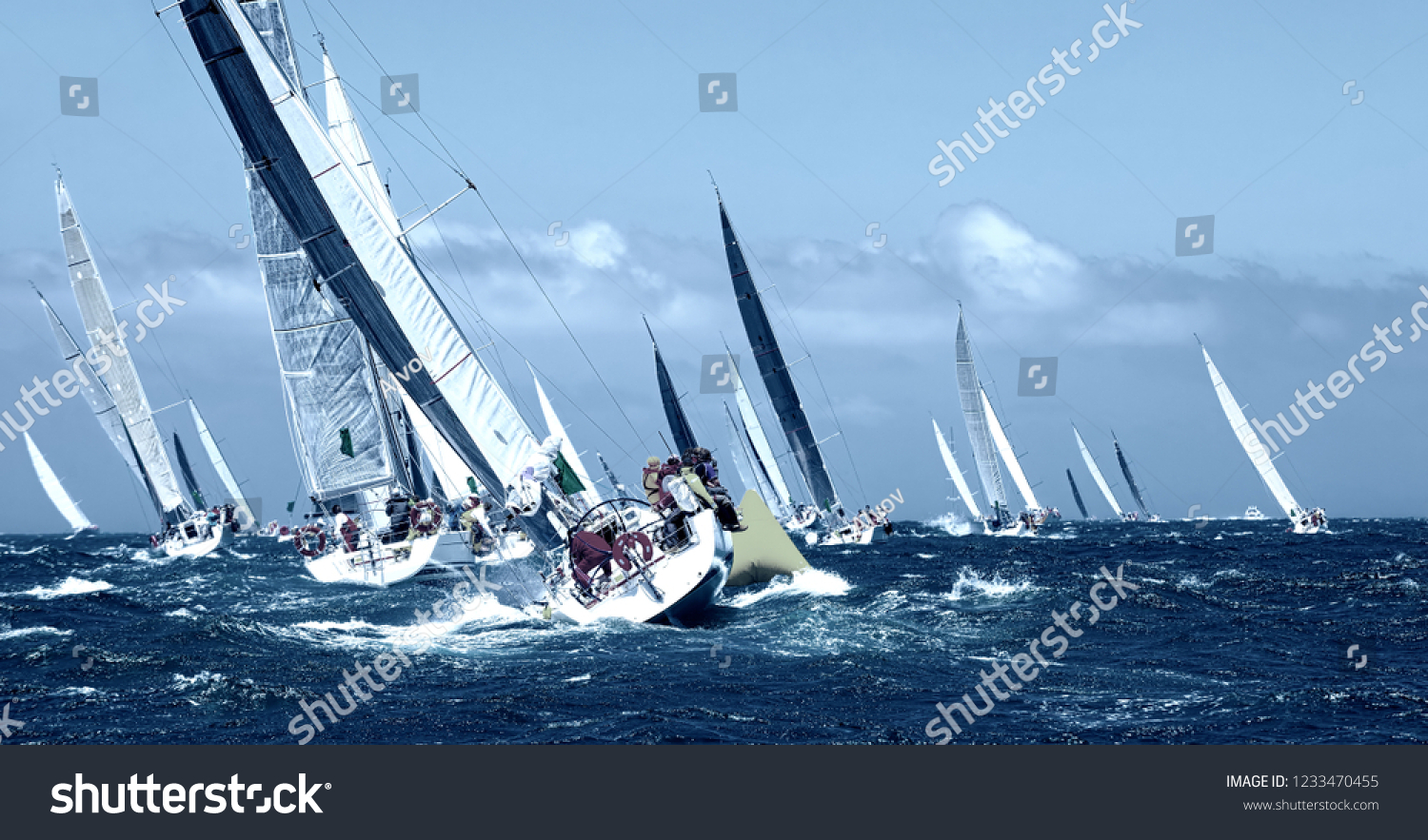 Sailboat under white sails at the regatta. Sailing yacht race