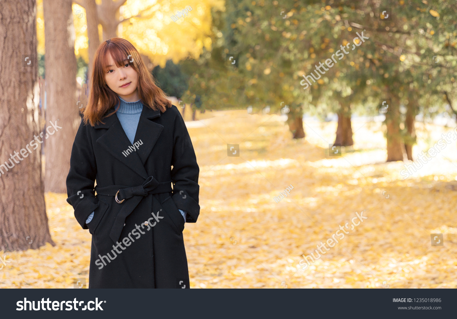 Beautiful Asian women in the autumn park.
