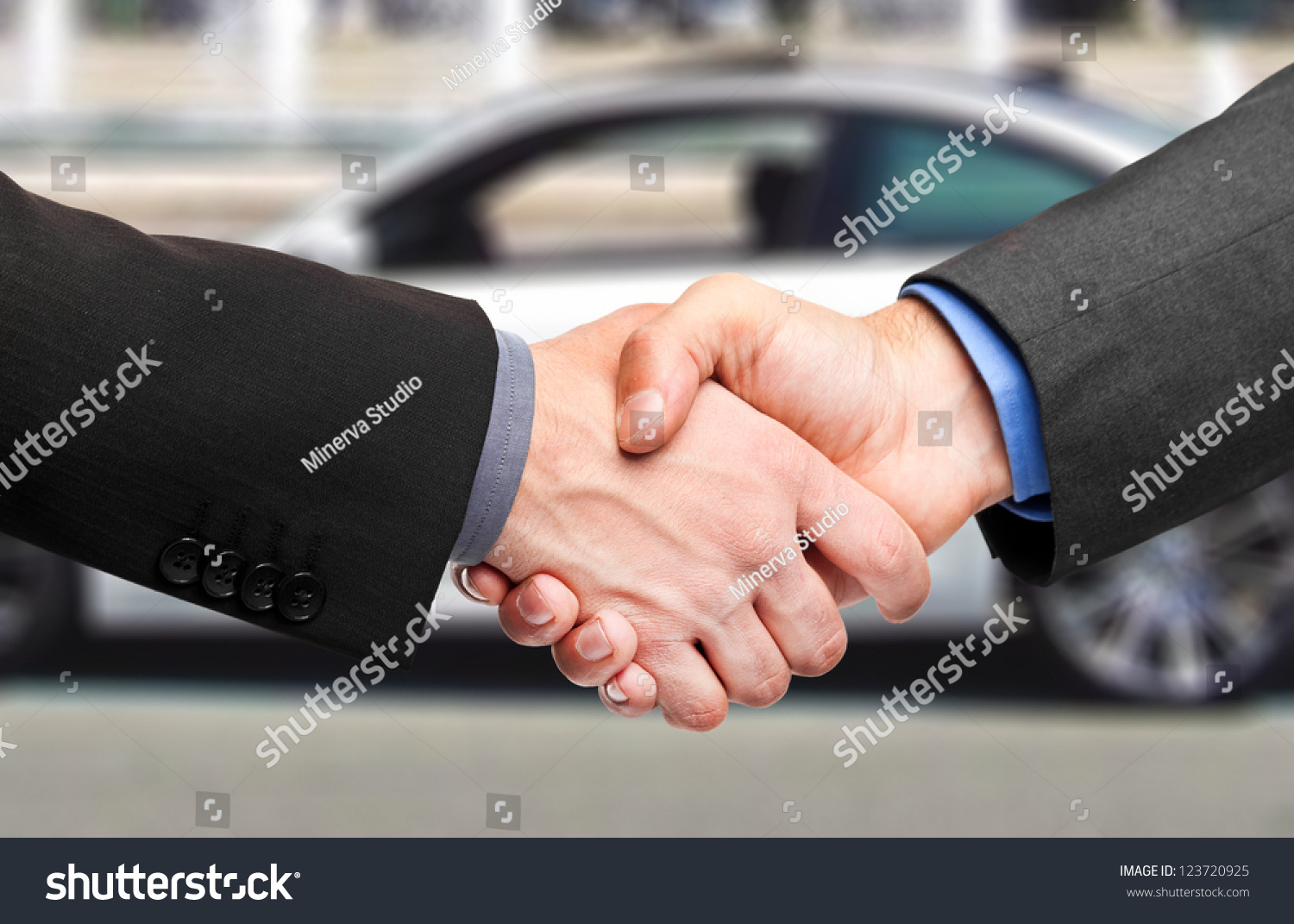 Business handshake to close the deal after buying a car