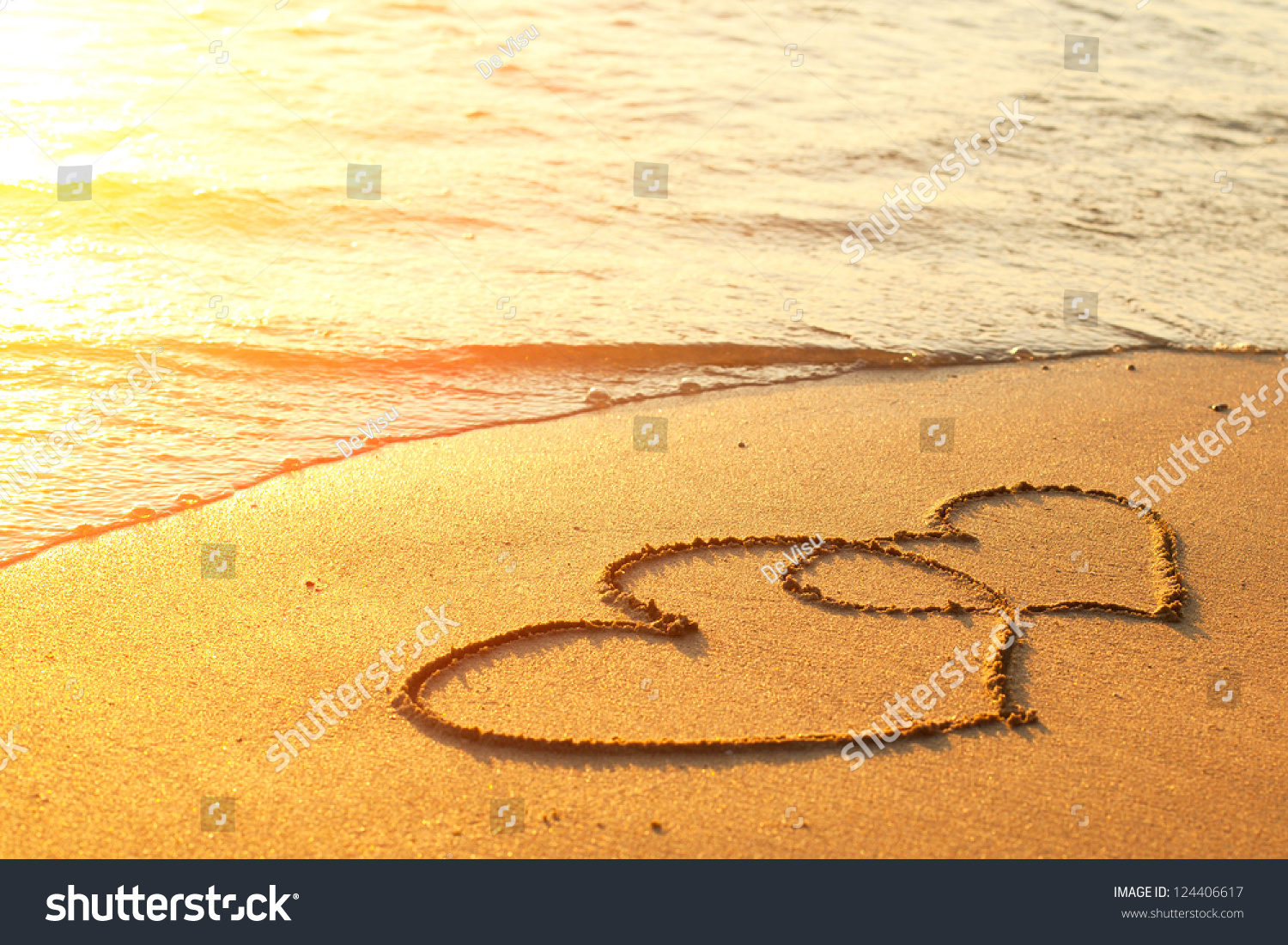 Hearts drawn on the sand of a beach