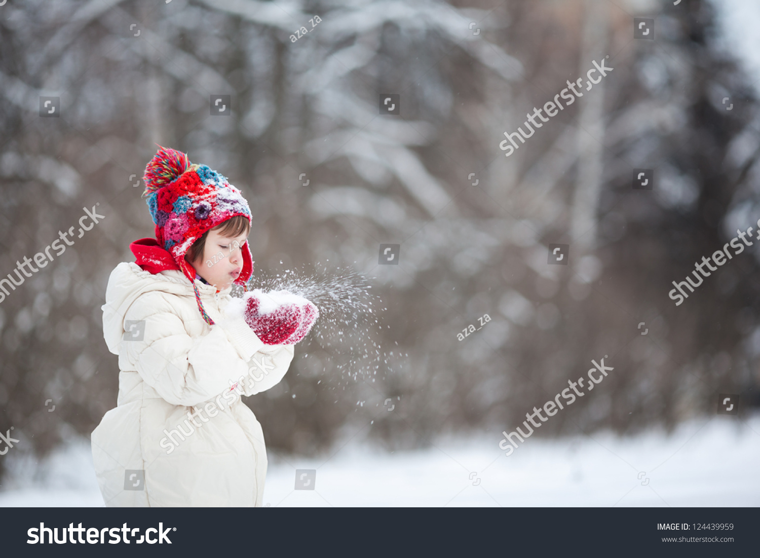 Small girl playing with snow